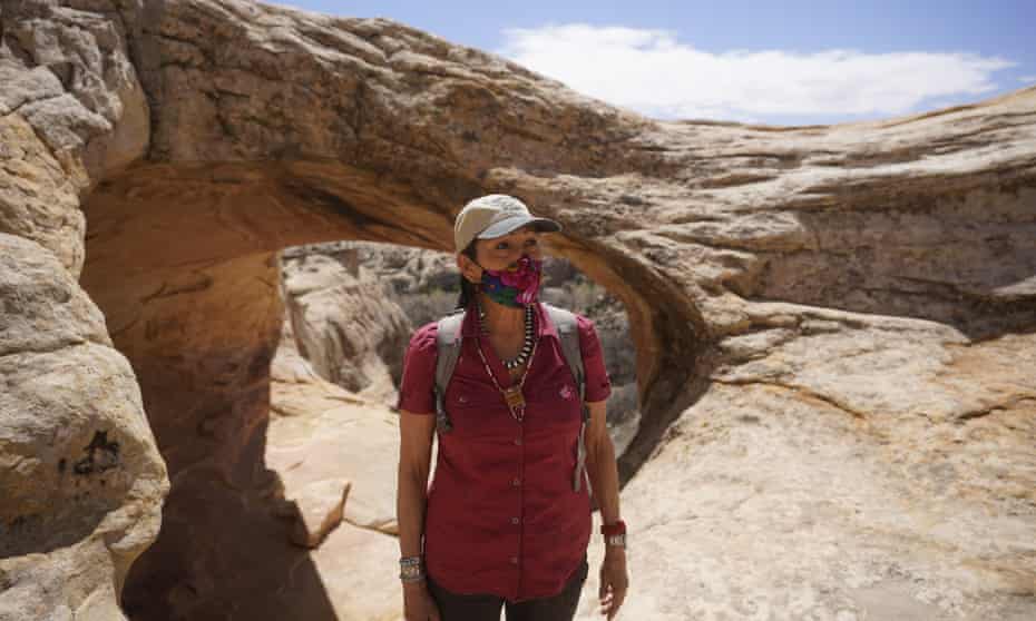 The interior secretary, Deb Haaland, tours near ancient dwellings along the Butler Wash trail during a visit to Bears Ears national monument on Thursday.