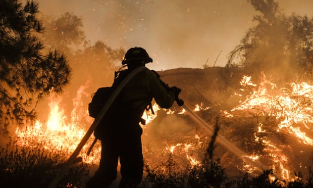 A firefighter battles a wildfire in California