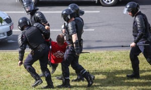 Police detain a man on Wednesday who tried to put flowers at the site where a protester died in Minsk, the capital of Belarus.