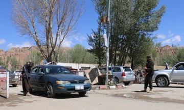 Taliban security officers by parked cars