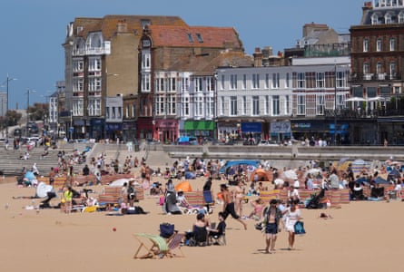 People on the beach on a sunny day in Margate, Kent.