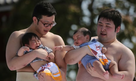 Two babies held by sumo wrestlers compete during the Crying Baby Contest at Sensoji Buddhist temple in Tokyo in 2014