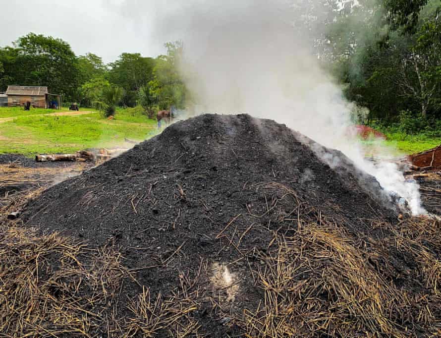 A charcoal kiln steams in San Agustín