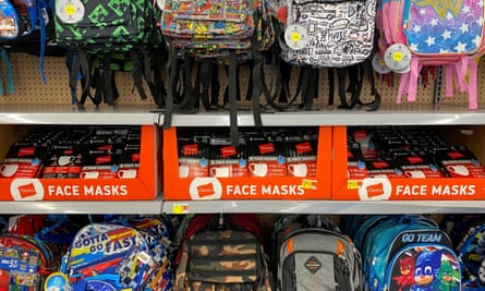 Face masks are shown for sale with backpacks and back to school supplies at a Walmart store in Encinitas, California.