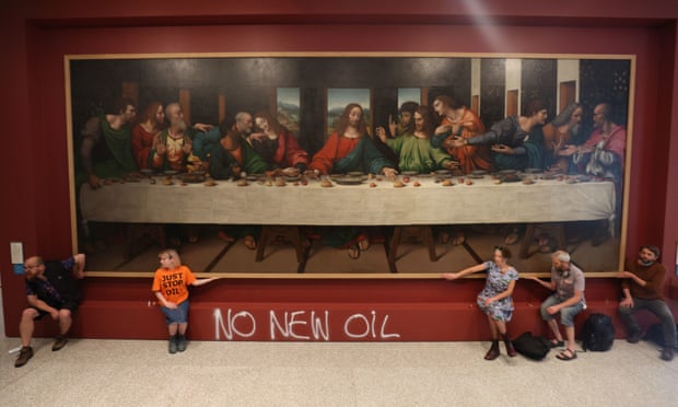 Protesters from the Just Stop Oil climate protest group glue their hands to the frame of a copy of Leonardo da Vinci's The Last Supper inside the Royal Academy on Tuesday.