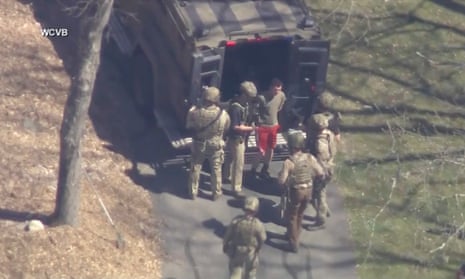 This image made from video provided by WCVB-TV, shows Jack Teixeira, in T-shirt and shorts, being taken into custody by armed tactical agents on Thursday, 13 April 2023, in Dighton, Mass.