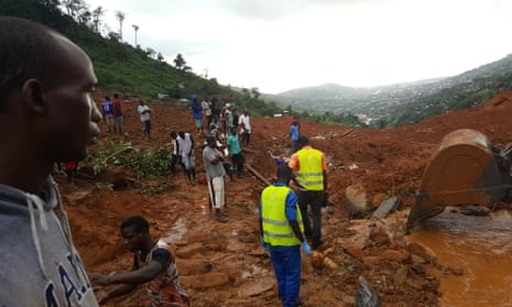 Rescue workers at the site of the mudslide in Freetown, Sierra Leone, that has so far claimed almost 400 lives