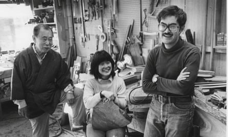 George Nakashima, left, with his children Mira and Kevin in the workshop at New Hope during the 1980s.