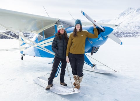 Friends Mary Creighton, 35, and Tosha Cypher, 38, stand with Cypher’s 1956 Pacer on the frozen surface of Lake George, Alaska