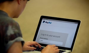 Logging in to PayPal on a laptop