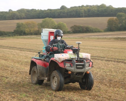 Slug pellets are spread from the back of a quad bike