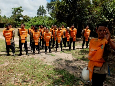 Members of Cambodia Self Help Demining (CSHD) assemble before performing checks for a controlled explosion.