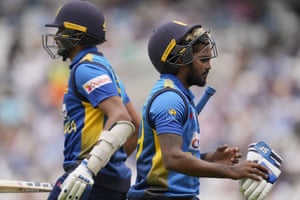 Wanindu Hasaranga, right, walks off the field of play after losing his wicket.