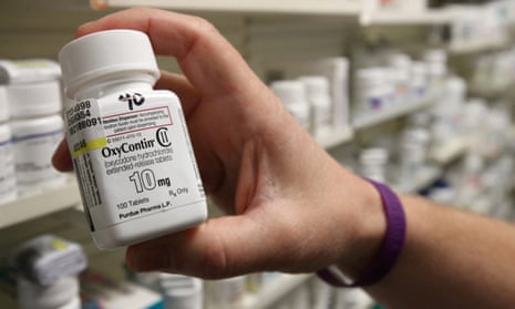 A pharmacist holds a bottle of OxyContin made by Purdue Pharma in 2019.