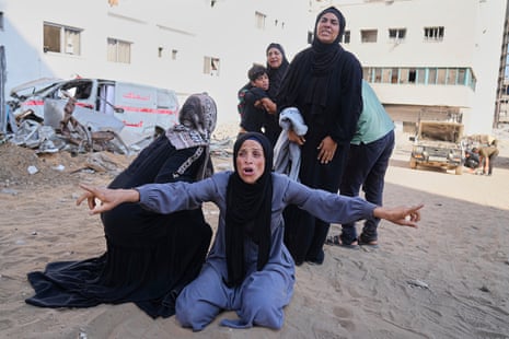 Palestinians mourn relatives who were killed while heading to an aid distribution hub, at Shifa Hospital in Gaza City, Wednesday, June 18, 2025.