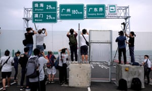 Members of the media take pictures of the Hong Kong-Zhuhai-Macau bridge