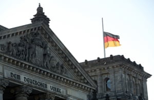The German flag flutters at half mast on the Reichstag building in Berlin