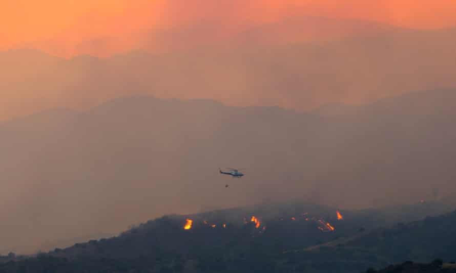 A helicopter flies over the forest fire in Cyprus