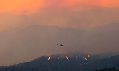 A helicopter flies over the forest fire in Cyprus.