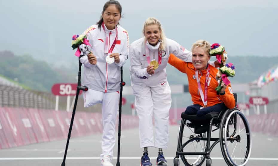 Oksana Masters celebrates her title with silver medalist Sun Bianbian (left) and the Netherlands’ Jennette Jansen (right), who finished third