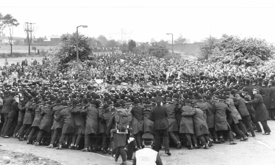 Police hold back striking miners on the picket line at Orgreave coking plant in Sheffield.