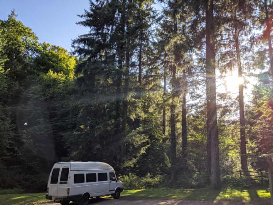 A van in woods.