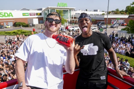 Logan Paul, left, and KSI pose for a photographer as they promote their Prime energy drinkoutside an Asda in London, Friday, June 17, 2022