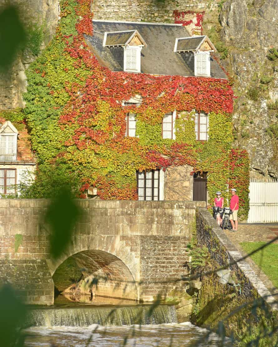 View of the picturesque old bridge and River Sarthe as it flows through Fresnay-sur-Sarthe in the Pays de Loire region of Western France.