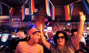 Revellers at the historic Stonewall Inn, an iconic gay bar, granted historic landmark status in June 2015.