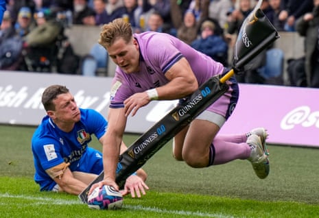 Duhan van der Merwe of Scotland beats the tackle from Paolo Garbisi of Italy and scores a try to give Scotland a 5-3 lead.