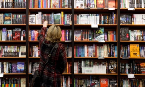 A woman browses books in a bookshop.