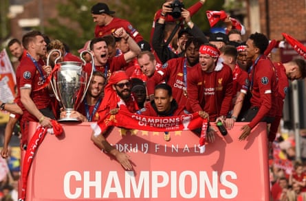 James Milner holds the European Cup atop the bus touring Liverpool after their victory in the 2019 Champions League final