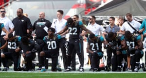 Jacksonville Jaguars players kneel in protest before their game against the Baltimore Ravens at Wembley Stadium in London on 24 September, the first NFL game of the day.