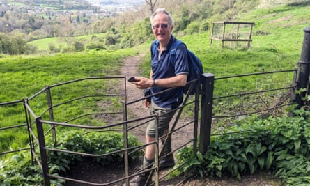 Steve Melia in countryside on a footpath, leaning on a gate