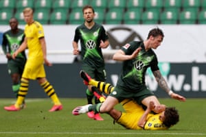 Ooff! Dortmund’s Thomas Delaney is on the deck after colliding with Wolfsburg’s Wout Weghorst.