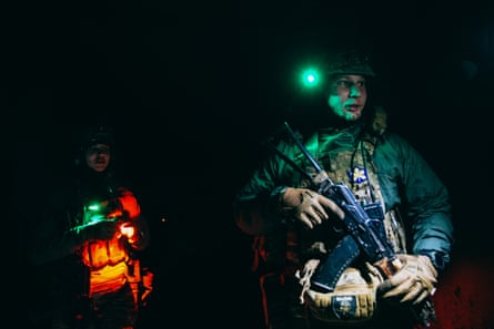 Iryna and Andrii, drone operators from the Khyzhak Brigade, head towards their underground position.