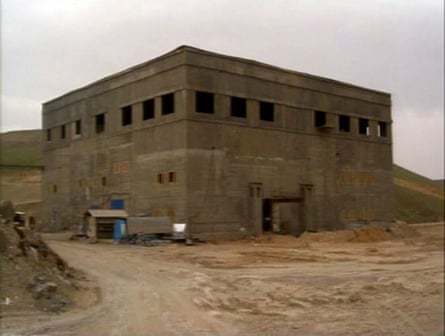 A large block-shaped building in the desert