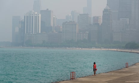 A lifeguard stands watch along the lakefront as wildfire smoke clouds the skyline on June 28, 2023 in Chicago, Illinois.
