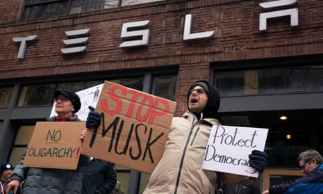 Protesters target Tesla showrooms in US over Elon Musk's government cost-cutting | Tesla | The Guardian