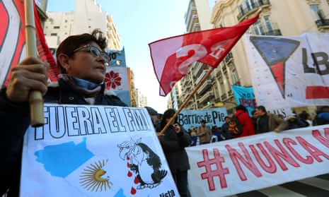 A demonstrator holds an anti-IMF sign during a protest against the G20 Meeting of Finance Ministers in Buenos Aires, Argentina, in July.