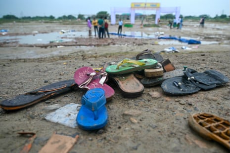 Shoes on the ground with people pictured in the background