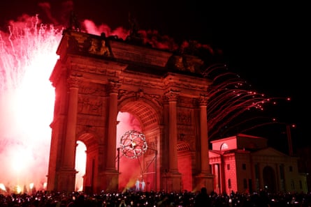 A firework display at the Arco della Pace after the lighting of the Olympic cauldron