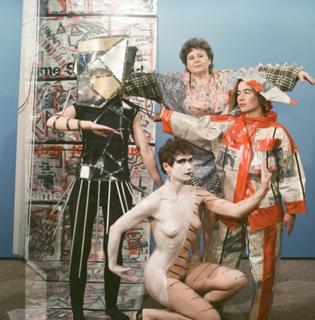 A photograph of four women dressed up and posing in odd shapes