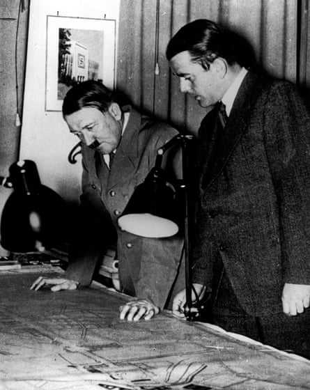 A black and white photograph of Hitler and Albert Speer looking at a map
