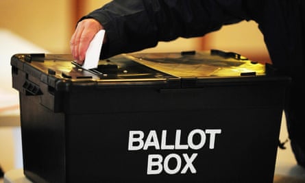 Person putting paper in ballot box