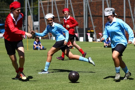 Players re-enact the original match in 1921 during the Australian Women’s Football Centenary Event at the Gabba on 24 September 2021 in Brisbane.