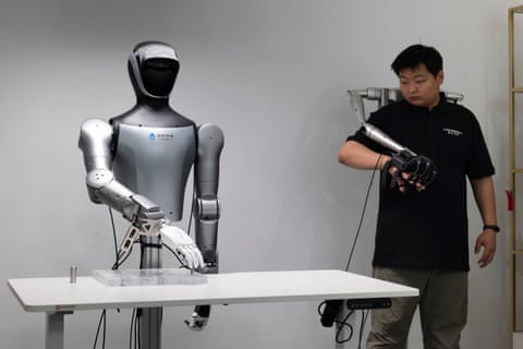 A technician demonstrates teleoperation controls on a humanoid robot