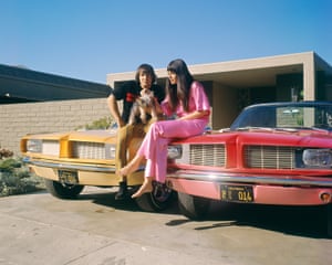 Sonny &amp; Cher in 1965, matching their pants to their convertibles. 