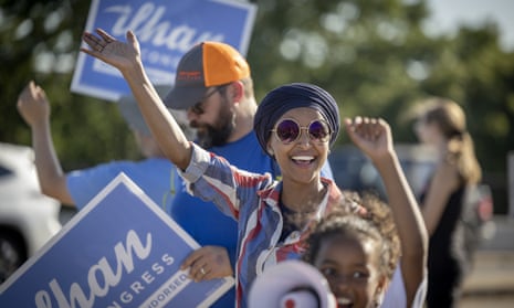 Congresswoman Ilhan Omar waves to passersby in Minneapolis on Tuesday. She saw off a centrist challenge from Don Samuels