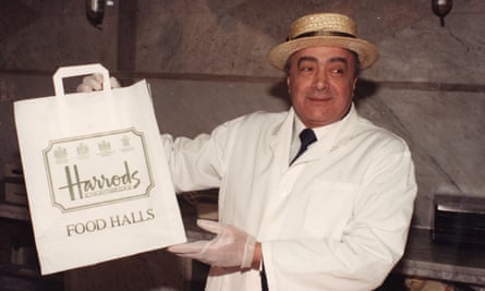 Mohamed Al Fayed pictured wearing a white coat and a straw hat in the Harrods food halls